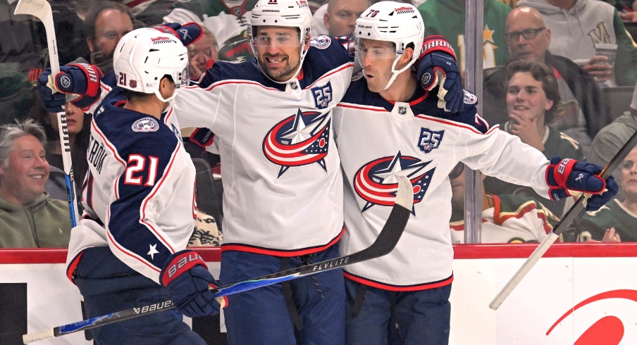 Oct 11, 2025; Saint Paul, Minnesota, USA; Columbus Blue Jackets forward Miles Wood (11) celebrates his goal against the Minnesota Wild with forward Isac Lundestrom (21) and defensemen Damon Severson (78) during the first period at Grand Casino Arena.