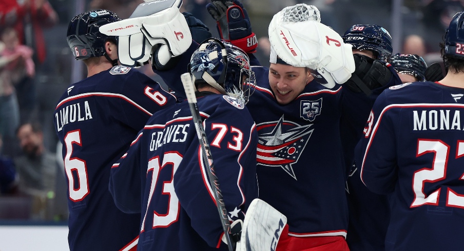 Jan 24, 2026; Columbus, Ohio, USA; Columbus Blue Jackets goaltender Elvis Merzlikins (facing) celebrates with Columbus Blue Jackets goaltender Jet Greaves (73) following the game against the Tampa Bay Lightning at Nationwide Arena.