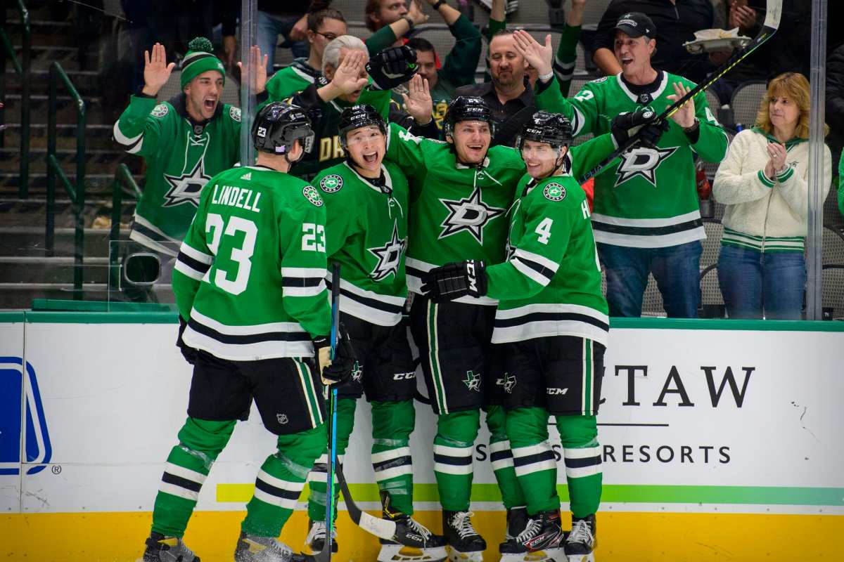 Nov 30, 2021; Dallas, Texas, USA; Dallas Stars defenseman Esa Lindell (23) and left wing Jason Robertson (21) and left wing Roope Hintz (24) and defenseman Miro Heiskanen (4) celebrates a second goal scored by Hintz against the Carolina Hurricanes during the second period at the American Airlines Center. Mandatory Credit: Jerome Miron-USA TODAY Sports