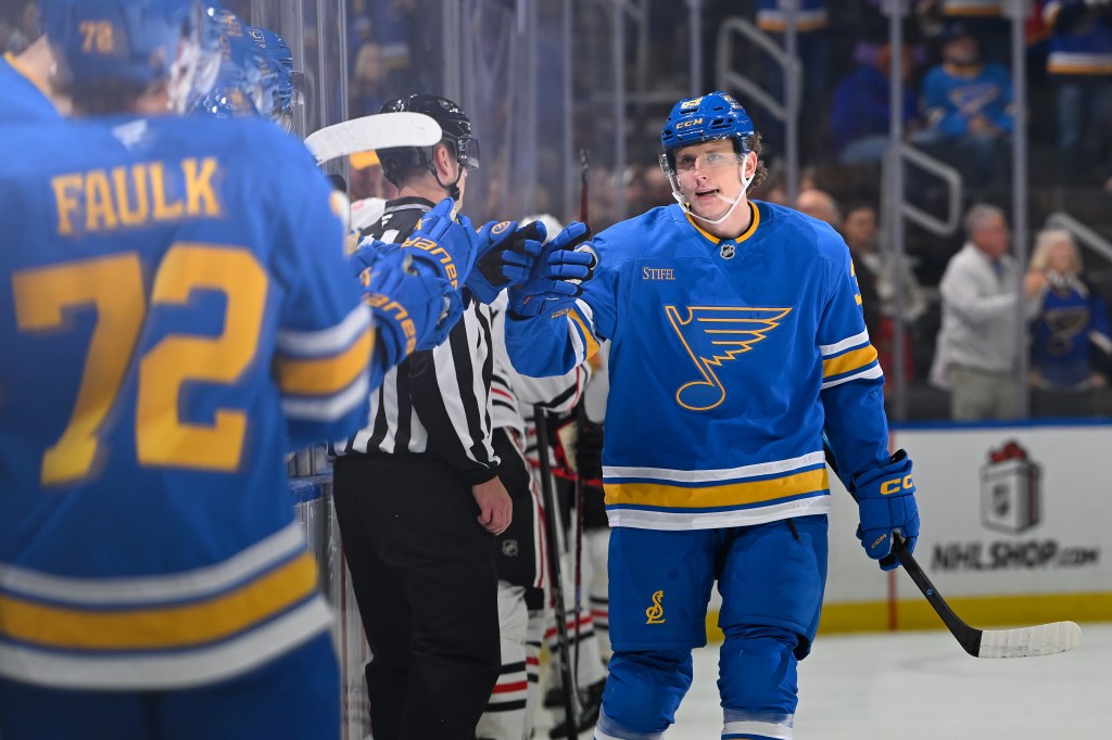 Matt Luff of the St. Louis Blues being congratulated after scoring a goal against the Chicago Blackhawks.