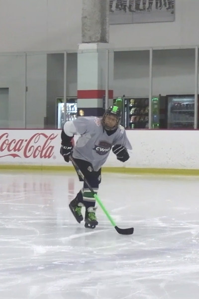 Vertical shot of Linda playing hockey