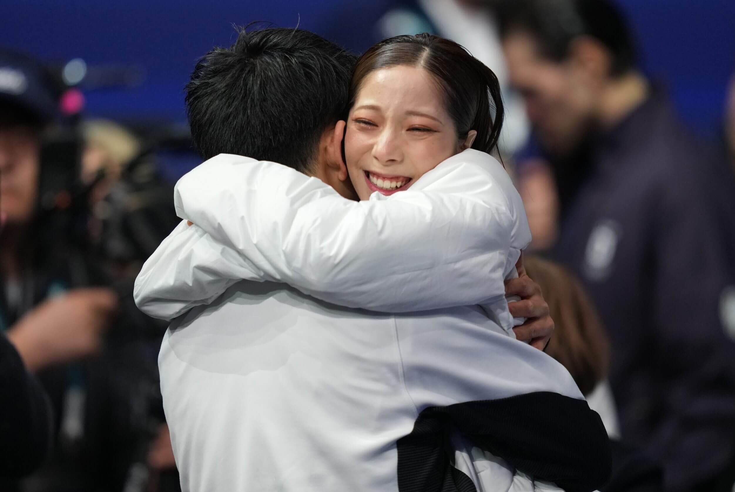 Riku Miura and Ryuichi Kihara of Japan celebrate after winning gold in the pairs free skate during the Milano Cortina 2026 Olympic Winter Games at Milano Ice Skating Arena.