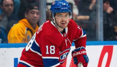 Montreal Canadiens center Robert Thomas (18), wearing the team's red home jersey and blue helmet, skates on the ice during a game, looking towards the camera.