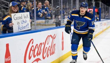 St. Louis Blues center Robert Thomas smiles as he skates past a female fan behind the glass holding a handmade sign that reads "Good luck in Utah Robert!" amidst heavy trade rumors involving the Utah Mammoth.