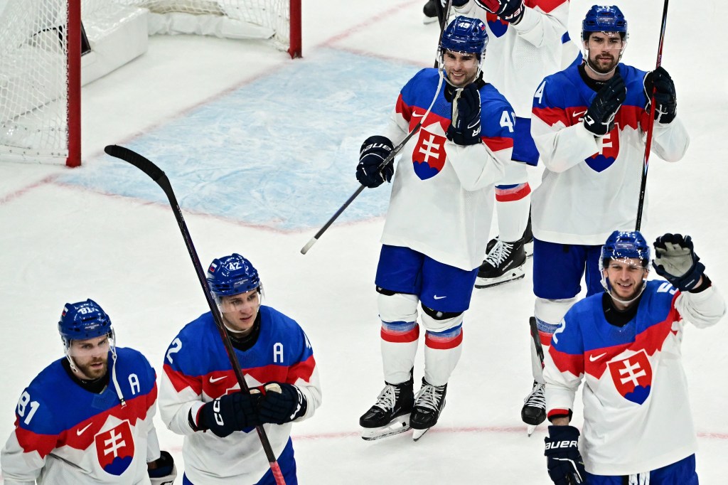 Slovakian ice hockey players celebrating on the ice after a match.