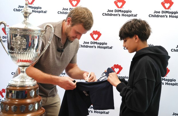 Florida Panthers Captain Aleksander "Sasha" Barkov, a longtime supporter of Joe DiMaggio Children's Hospital, signs an autograph for David Goodis,14, of  Parkland , during a special party for pediatric patients and their families at Joe DiMaggio Children's Hospital in Hollywood on Tuesday, February 24, 2026. (Carline Jean/South Florida Sun Sentinel)