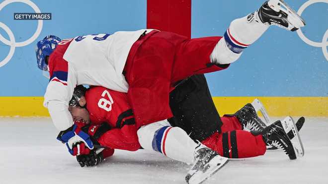 Czech Republic's Radko Gudas tackles Canada's Sidney Crosby during the men's playoff quarterfinal match between Canada and Czech Republic at the Milano Santagiulia Ice Hockey Arena during the Milano Cortina 2026 Winter Olympic Games in Milan on February 18, 2026. (Photo by Alexander NEMENOV / AFP via Getty Images)