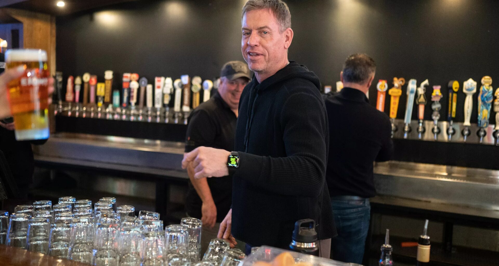 Troy Aikman tending bar at The Katy Trail Ice House
