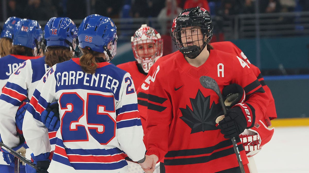 Team USA and Canada shake hands