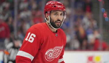 NHL center Vincent Trocheck depicted wearing a Detroit Red Wings home jersey with the number 16 and a corresponding red helmet while on the ice during a game.