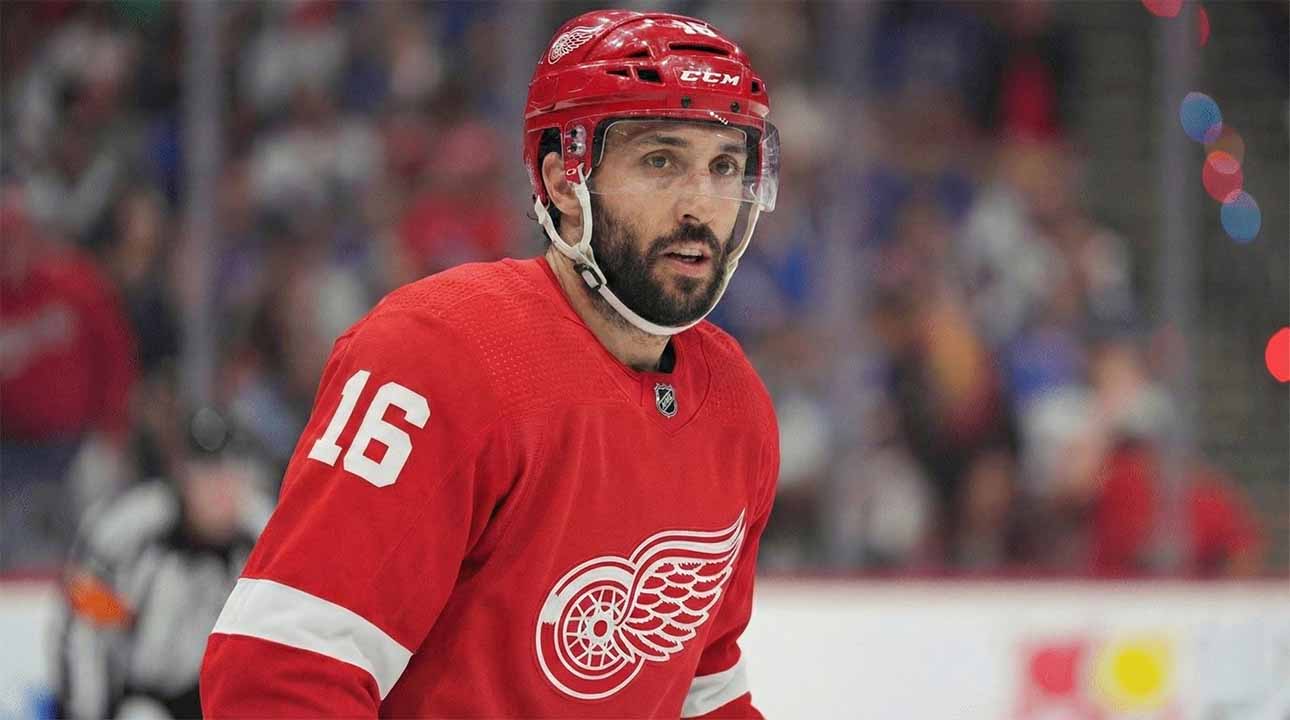 NHL center Vincent Trocheck depicted wearing a Detroit Red Wings home jersey with the number 16 and a corresponding red helmet while on the ice during a game.