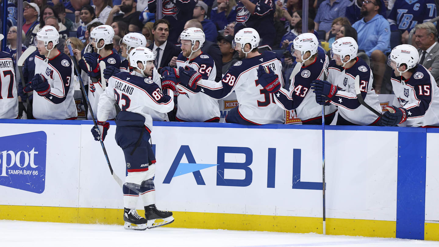 Blue Jackets forward Conor Garland celebrates a goal against the Tampa Bay Lightning with the CBJ bench.