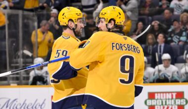 Mar 19, 2026; Nashville, Tennessee, USA;  Nashville Predators left wing Filip Forsberg (9) celebrates with his teammates after scoring a goal against the Seattle Kraken during the third period at Bridgestone Arena. Mandatory Credit: Steve Roberts-Imagn Images