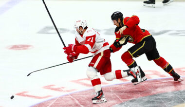 Feb 26, 2026; Ottawa, Ontario, CAN; Detroit Red Wings center Dylan Larkin (71) and Ottawa Senators defenseman Jake Sanderson (85) chase the puck during the third period at Canadian Tire Centre. Mandatory Credit: Keito Newman-Imagn Images