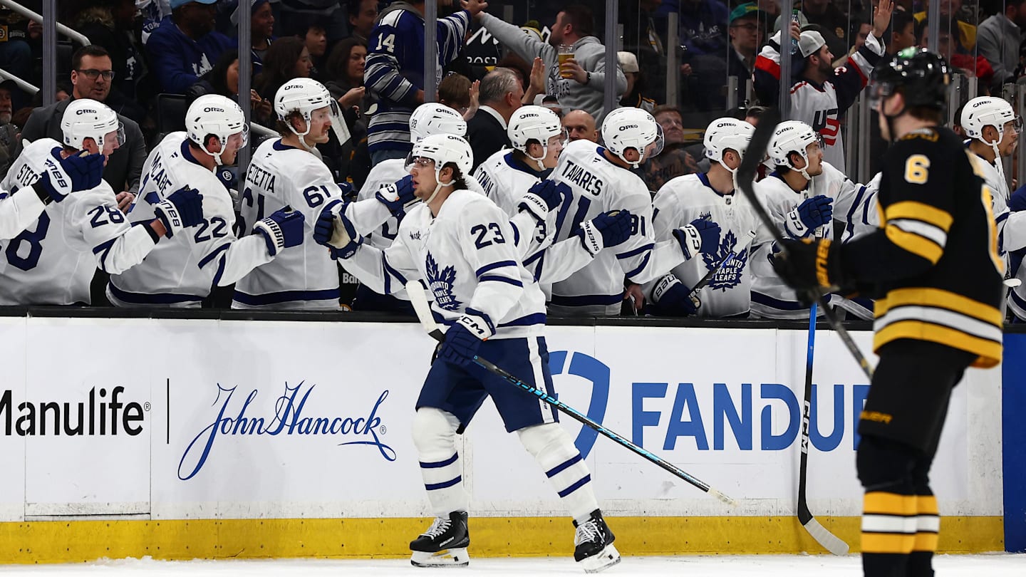 Mar 24, 2026; Boston, Massachusetts, USA; As Boston Bruins defenseman Mason Lohrei (6) heads for his bench, Toronto Maple Leafs left wing Matthew Knies (23) is congratulated at the bench after scoring a shorthanded goal during the second period at TD Garden. Mandatory Credit: Winslow Townson-Imagn Images