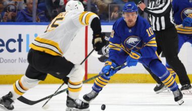 Mar 25, 2026; Buffalo, New York, USA;  Boston Bruins defenseman Jonathan Aspirot (45) makes a pass as Buffalo Sabres center Sam Carrick (10) defends during the second period at KeyBank Center. Mandatory Credit: Timothy T. Ludwig-Imagn Images