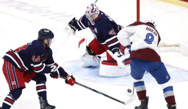 Mar 14, 2026; Winnipeg, Manitoba, CAN; Winnipeg Jets defenseman Josh Morrissey (44) stick checks Colorado Avalanche defenseman Cale Makar (8) in front of Winnipeg Jets goaltender Connor Hellebuyck (37) in the first period at Canada Life Centre. Mandatory Credit: James Carey Lauder-Imagn Images