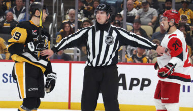 Mar 22, 2026; Pittsburgh, Pennsylvania, USA;  NHL linesman James Tobias (61) separates Pittsburgh Penguins right wing Egor Chinakhov (59) and Carolina Hurricanes center Sebastian Aho (20) during the second period at PPG Paints Arena. Mandatory Credit: Charles LeClaire-Imagn Images