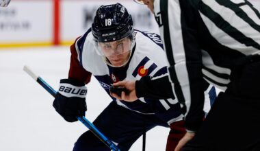 Mar 18, 2026; Denver, Colorado, USA; Colorado Avalanche center Jack Drury (18) watches the puck in the hand of linesman Devin Berg (87) before a face off in the second period against the Dallas Stars at Ball Arena. Mandatory Credit: Isaiah J. Downing-Imagn Images