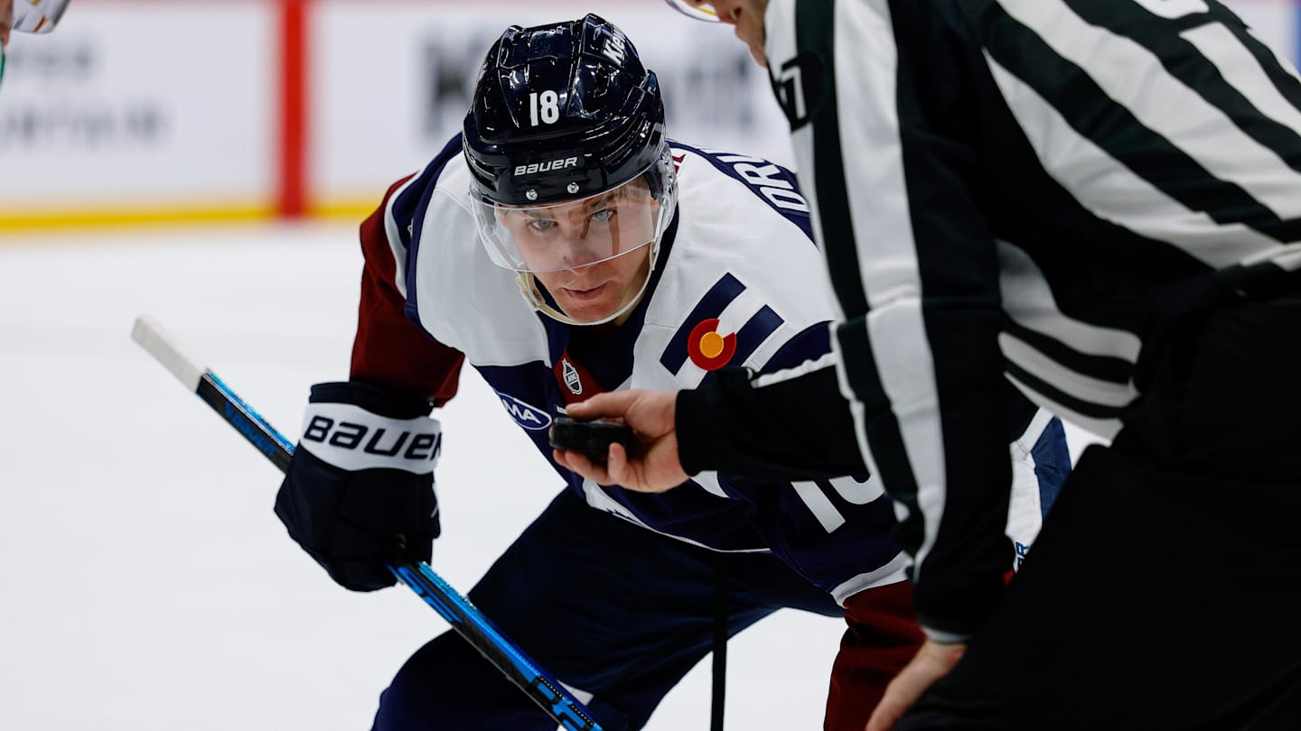 Mar 18, 2026; Denver, Colorado, USA; Colorado Avalanche center Jack Drury (18) watches the puck in the hand of linesman Devin Berg (87) before a face off in the second period against the Dallas Stars at Ball Arena. Mandatory Credit: Isaiah J. Downing-Imagn Images