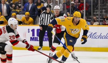 Mar 26, 2026; Nashville, Tennessee, USA;  Nashville Predators defenseman Adam Wilsby (83) steals the puck from New Jersey Devils right wing Lenni Hameenaho (29) during the first period at Bridgestone Arena. Mandatory Credit: Steve Roberts-Imagn Images