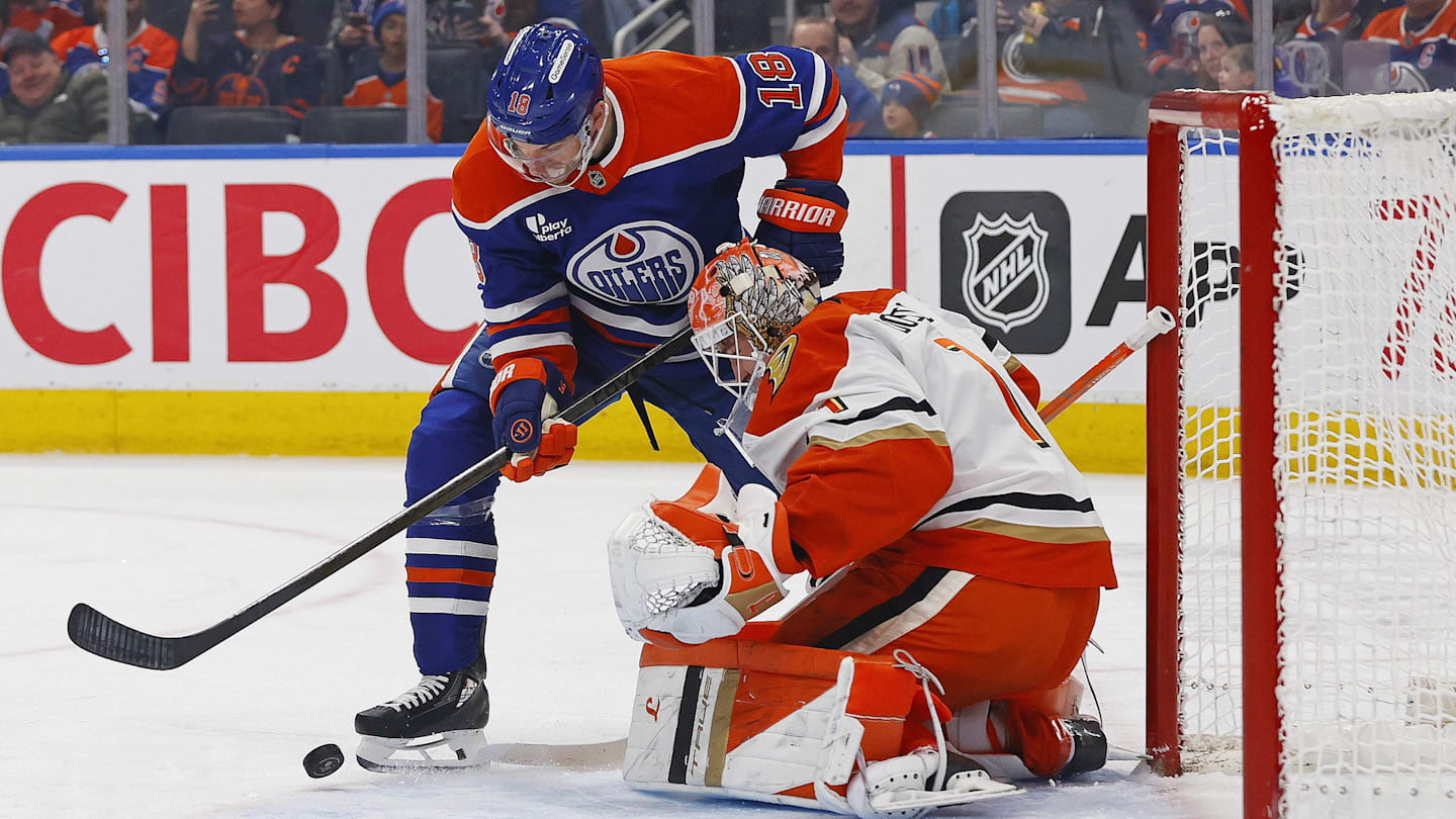 Mar 28, 2026; Edmonton, Alberta, CAN; Edmonton Oilers forward Zach Hyman (18) tries to get to a loose puck in front of Anaheim Ducks goaltender Lucas Dostal (1) during the first period at Rogers Place. Mandatory Credit: Perry Nelson-Imagn Images