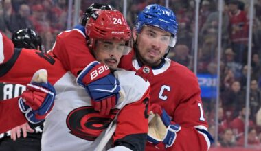 Mar 24, 2026; Montreal, Quebec, CAN; Montreal Canadiens forward Nick Suzuki (14) stops Carolina Hurricanes forward Seth Jarvis (24) from grabbing Montreal Canadiens defenseman Lane Hutson (48) during the second period at the Bell Centre. Mandatory Credit: Eric Bolte-Imagn Images