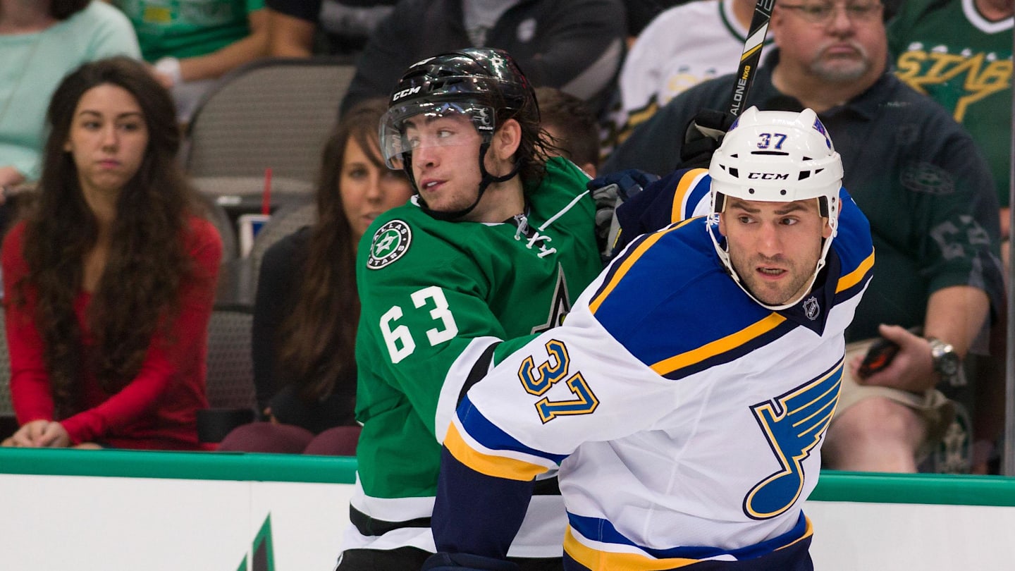 Sep 22, 2014; Dallas, TX, USA; Dallas Stars left wing Remi Elie (63) and St. Louis Blues left wing Paul Bissonnette (37) chase the puck during the game at the American Airlines Center. The Stars defeated the Blues 4-3. Mandatory Credit: Jerome Miron-Imagn Images
