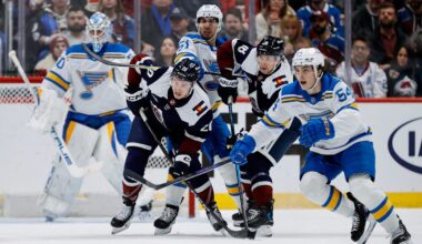 Dec 31, 2025; Denver, Colorado, USA; Colorado Avalanche center Ross Colton (20) and center Jack Drury (18) battle for position with St. Louis Blues defenseman Matthew Kessel (51) as right wing Dalibor Dvorsky (54) defends in the first period at Ball Arena. Mandatory Credit: Isaiah J. Downing-Imagn Images