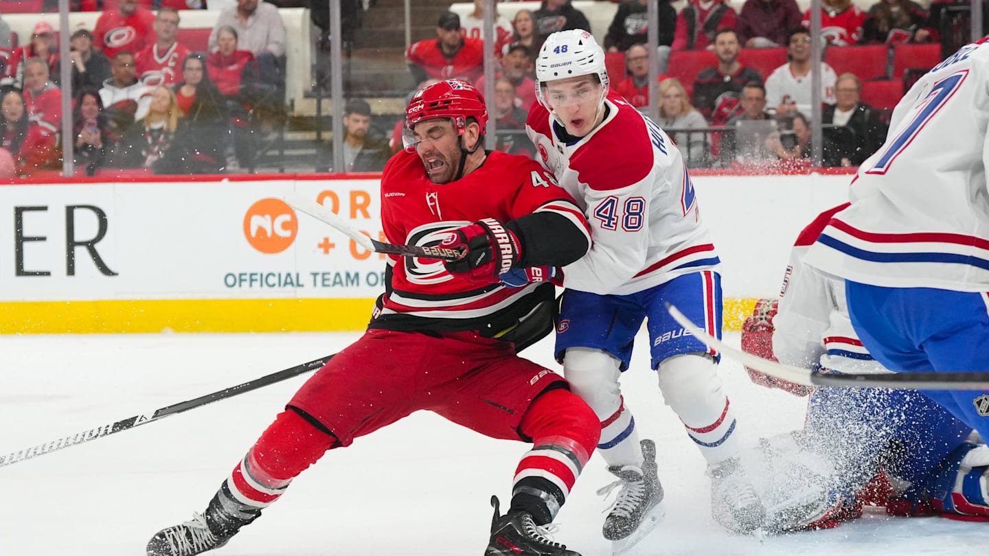 Mar 29, 2026; Raleigh, North Carolina, USA;  Montreal Canadiens defenseman Lane Hutson (48) and Carolina Hurricanes left wing Jordan Martinook (48) battle in front of the net ]during the first period at Lenovo Center. Mandatory Credit: James Guillory-Imagn Images