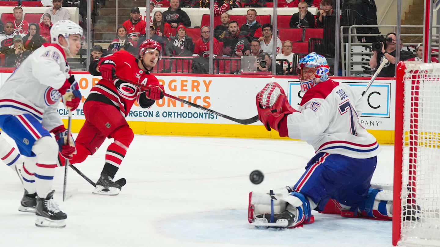 Mar 29, 2026; Raleigh, North Carolina, USA;  Carolina Hurricanes center Sebastian Aho (20) misses on his shot attempt against Montreal Canadiens goaltender Jakub Dobes (75) during the third period at Lenovo Center. Mandatory Credit: James Guillory-Imagn Images