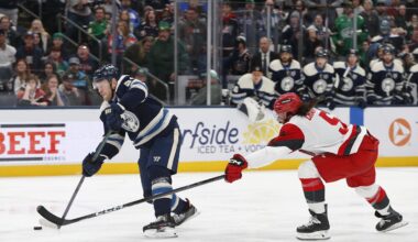 Mar 17, 2026; Columbus, Ohio, USA; Columbus Blue Jackets center Mathieu Olivier (24) wrists a shot on goal as Carolina Hurricanes defenseman Jalen Chatfield (5) defends during the second period at Nationwide Arena. Mandatory Credit: Russell LaBounty-Imagn Images
