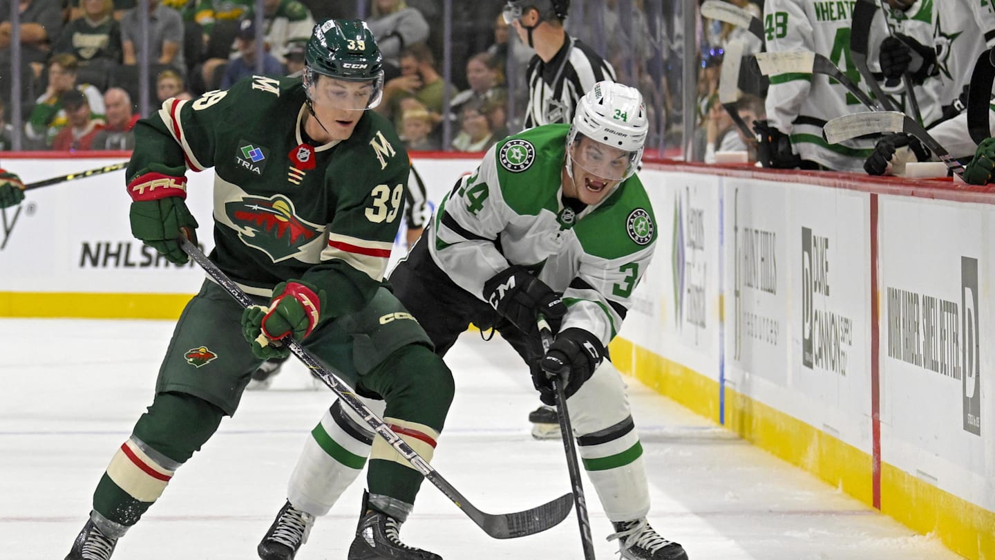 Sep 29, 2024; Saint Paul, Minnesota, USA;  Minnesota Wild forward Ben Jones (39) and Dallas Stars forward Cameron Hughes (34) battle for the puck during the second period at Xcel Energy Center. Mandatory Credit: Nick Wosika-Imagn Images
