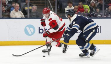Mar 17, 2026; Columbus, Ohio, USA; Carolina Hurricanes defenseman Mike Reilly (6) carries the puck as Columbus Blue Jackets defenseman Zach Werenski (8) defends during the third period at Nationwide Arena. Mandatory Credit: Russell LaBounty-Imagn Images
