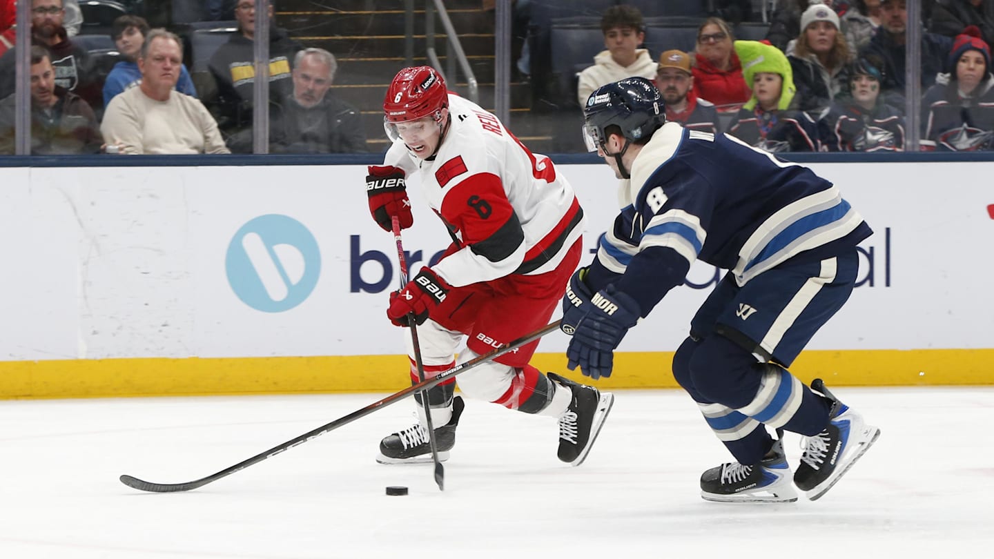 Mar 17, 2026; Columbus, Ohio, USA; Carolina Hurricanes defenseman Mike Reilly (6) carries the puck as Columbus Blue Jackets defenseman Zach Werenski (8) defends during the third period at Nationwide Arena. Mandatory Credit: Russell LaBounty-Imagn Images