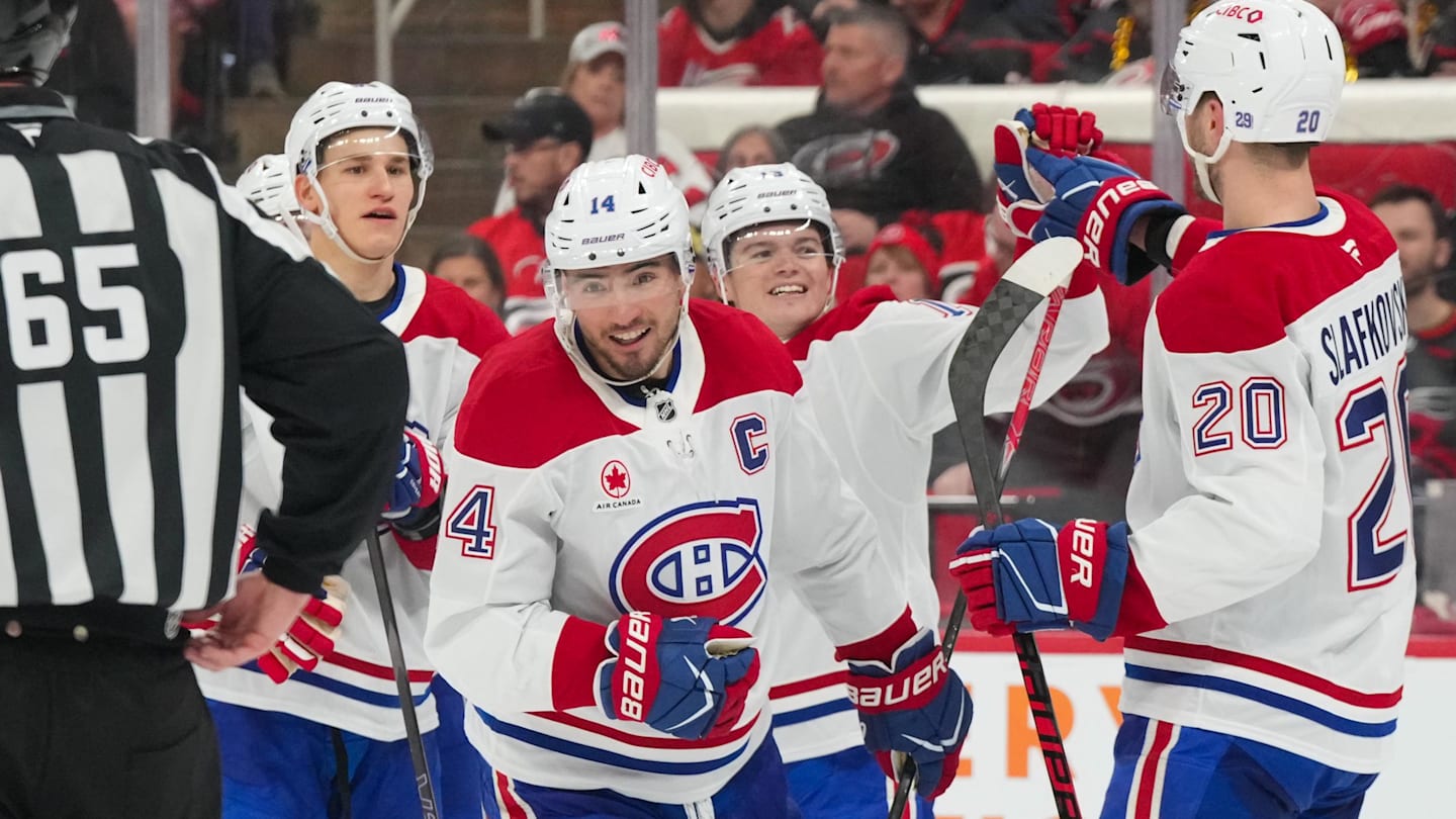 Mar 29, 2026; Raleigh, North Carolina, USA;  Montreal Canadiens center Nick Suzuki (14) celebrates his goal with left wing Juraj Slafkovsky (20), right wing Cole Caufield (13) and right wing Ivan Demidov (93) against the Carolina Hurricanes during the third period at Lenovo Center. Mandatory Credit: James Guillory-Imagn Images