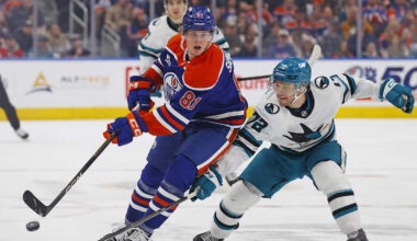 Jan 29, 2026; Edmonton, Alberta, CAN; Edmonton Oilers forward Josh Samanski (81) chips the puck past .San Jose Sharks forward William Eklund (72) during the first period  at Rogers Place. Mandatory Credit: Perry Nelson-Imagn Images