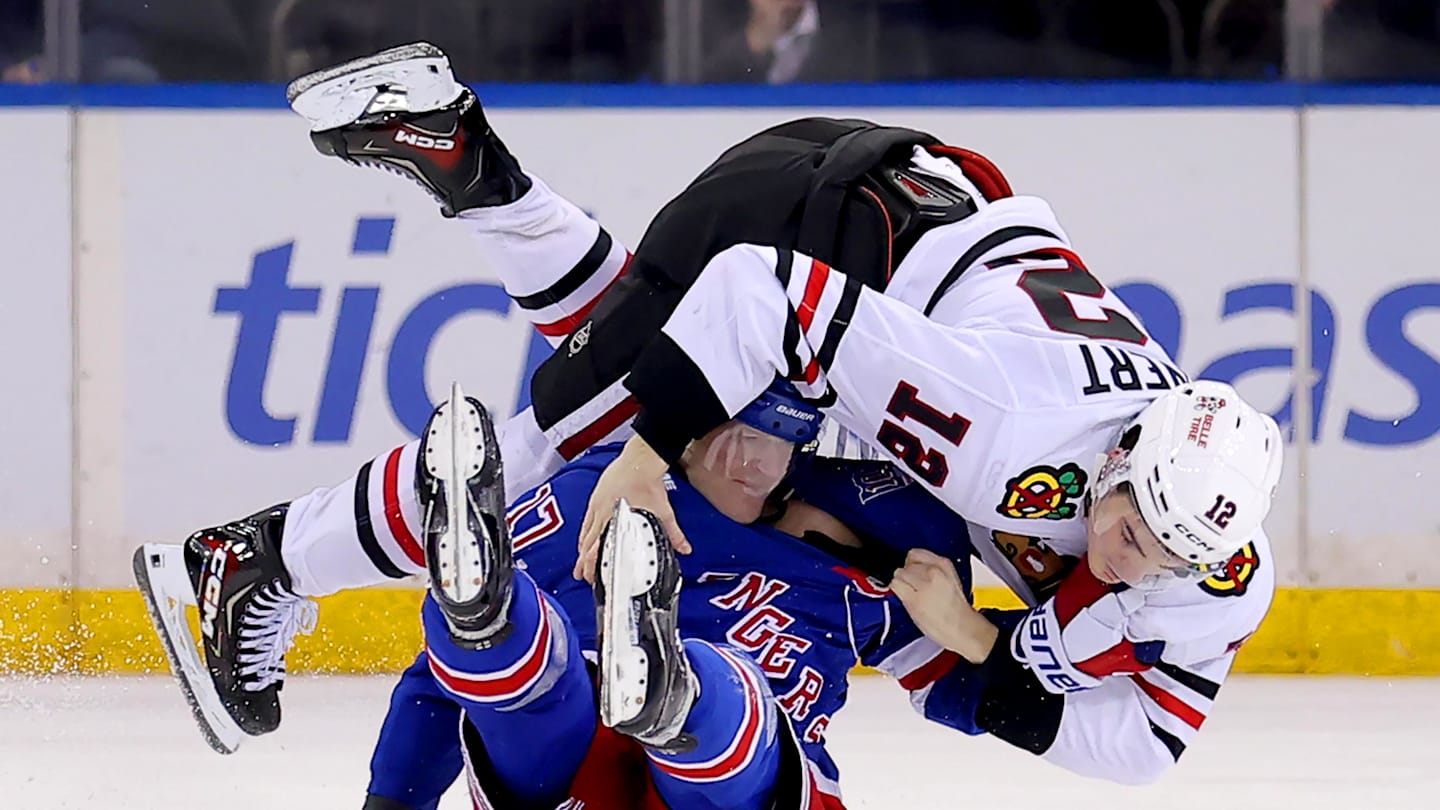 Mar 27, 2026; New York, New York, USA; Chicago Blackhawks center Sacha Boisvert (12) fights with New York Rangers defenseman Will Borgen (17) during the third period at Madison Square Garden. Mandatory Credit: Brad Penner-Imagn Images