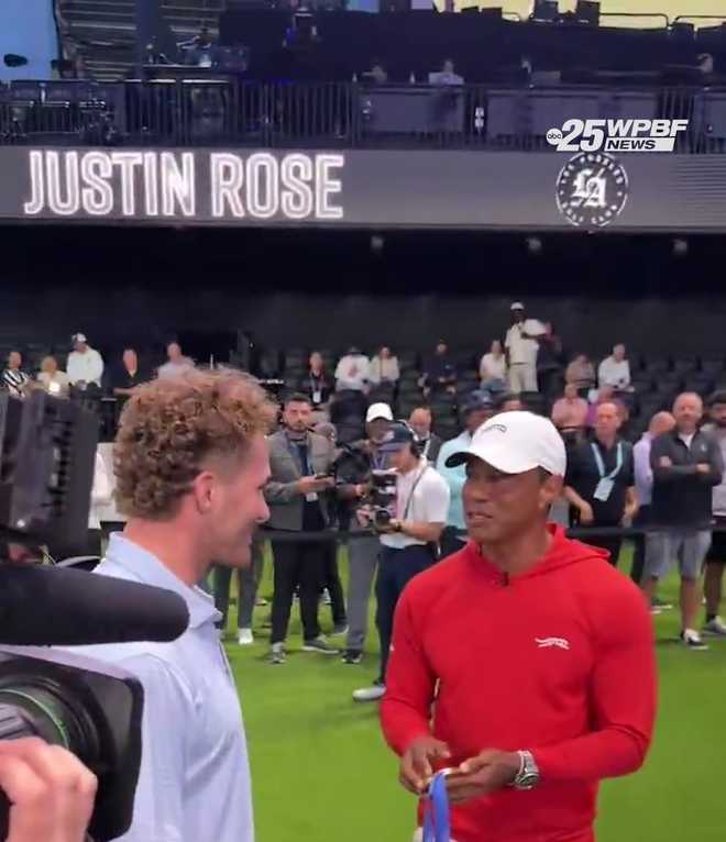 Florida Panthers' Matthew Tkachuk shows golf legend Tiger Woods his 2026 Olympic men's hockey gold medal we won with Team USA at the TGL Finals.