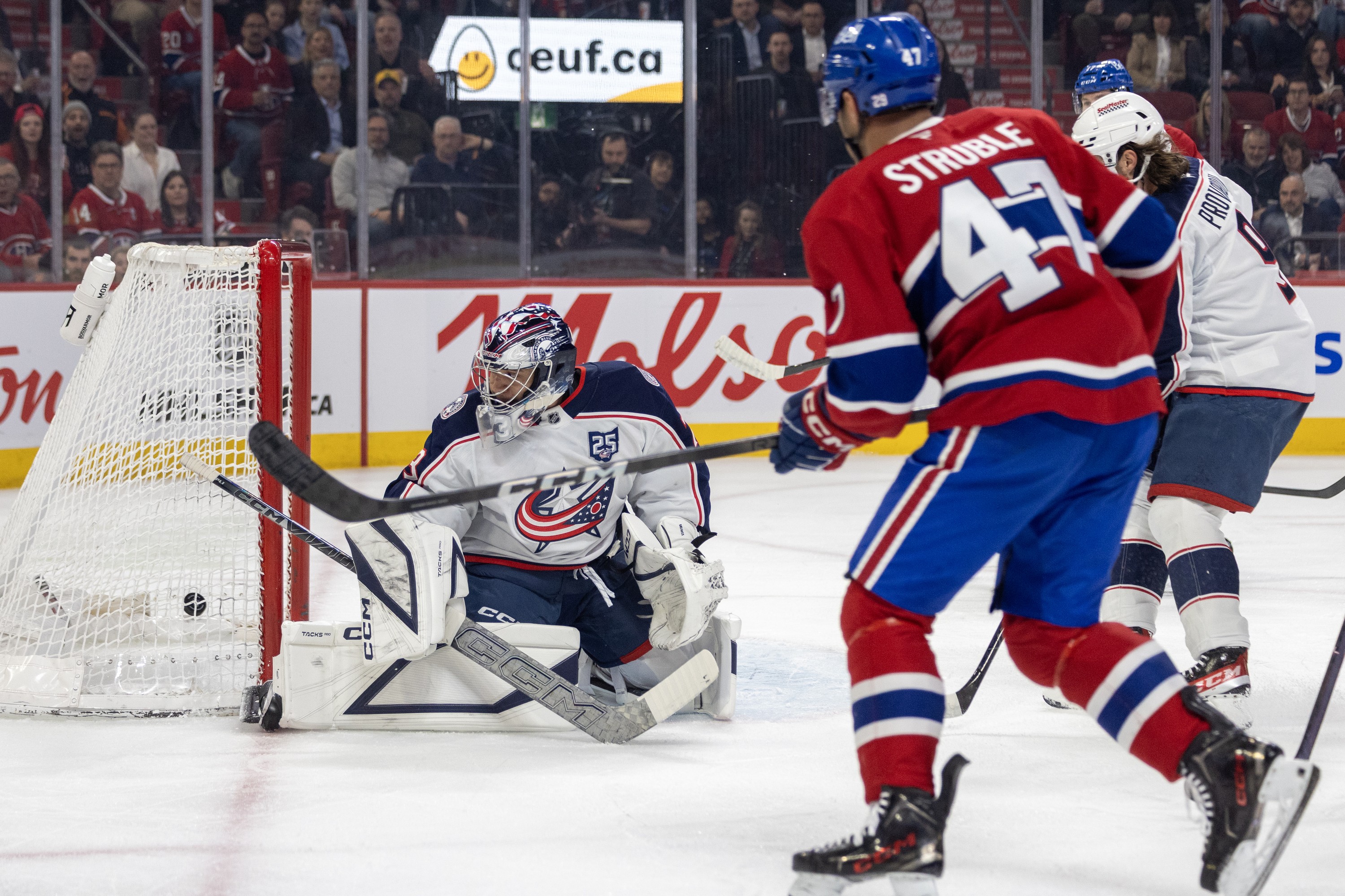 Canadiens defenceman Jayden Struble scores his first goal of the season on Columbus Blue Jackets' Jet Greaves during first period in Montreal on Thursday.
