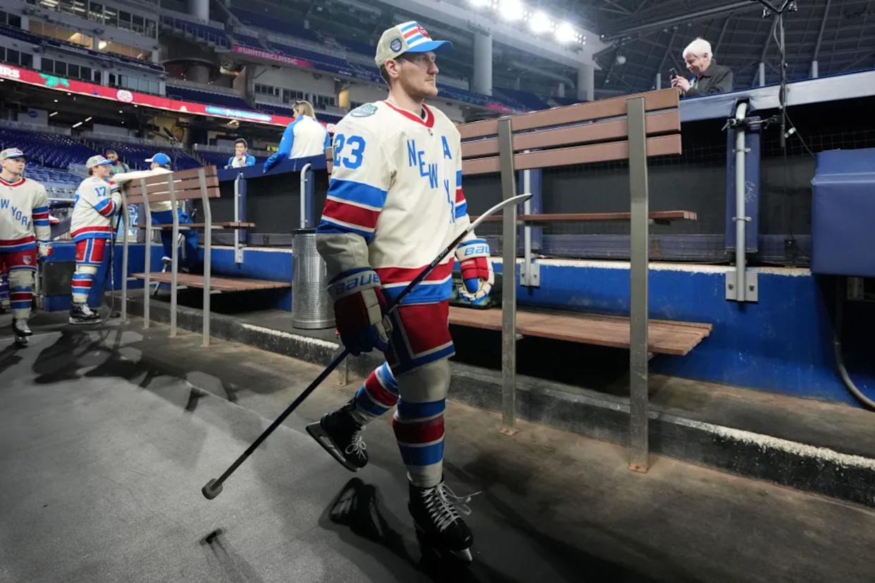 An image collage containing 1 images, Image 1 shows Adam Fox #23 of the New York Rangers makes his way to the ice before practice for the 2026 Discover NHL Winter Classic between the New York Rangers and the Florida Panthers at loanDepot park on January 01, 2026 in Miami, Florida