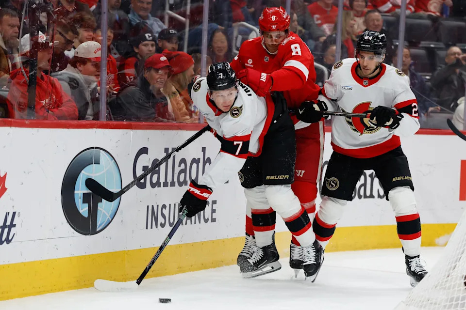 Mar 24, 2026; Detroit, Michigan, USA; Ottawa Senators left wing Brady Tkachuk (7) and Detroit Red Wings defenseman Ben Chiarot (8) battle for the puck in the first period at Little Caesars Arena. Mandatory Credit: Rick Osentoski-Imagn Images