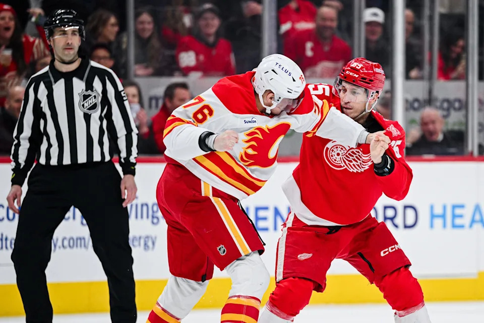 Calgary Flames center Martin Pospisil (76) and Detroit Red Wings right wing Dominik Shine (65) fight during the first period at Little Caesars Arena in Detroit on Monday, March 16, 2026.