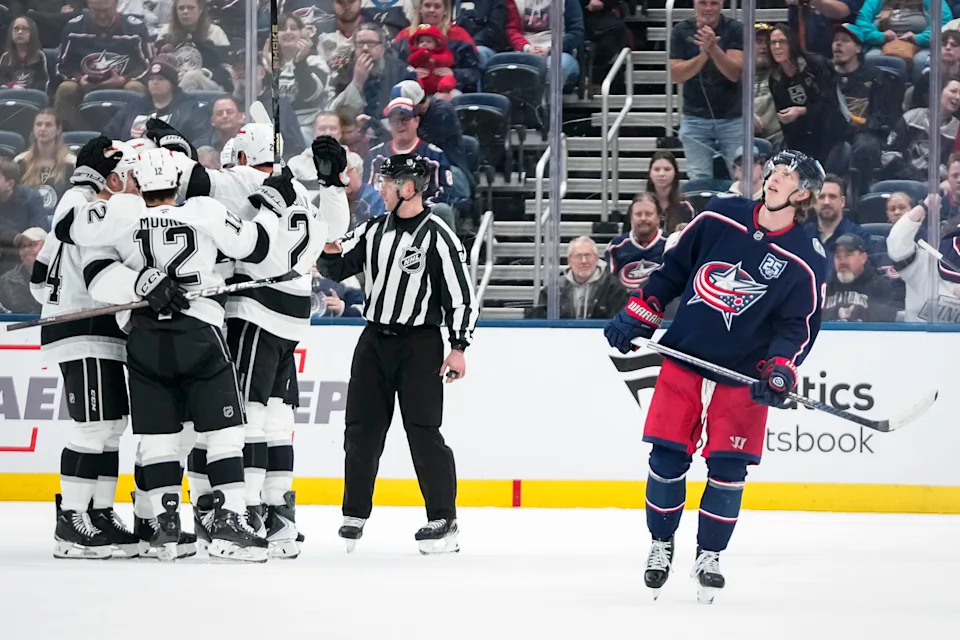 Columbus Blue Jackets center Kent Johnson (91) reacts to a goal by Los Angeles Kings defenseman Brian Dumoulin (2) during the third period of the NHL hockey game at Nationwide Arena in Columbus on March 9, 2026. The Blue Jackets lost 5-4 in overtime.