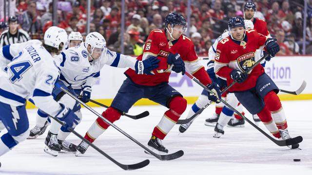 Florida Panthers defenseman Niko Mikkola (77) and Tampa Bay Lightning defenseman Emil Lilleberg (78) compete for the puck in the first period of their NHL game at the Amerant Bank Arena on Saturday, Nov. 15, 2025, in Sunrise, Fla. Florida Panthers defenseman Niko Mikkola (77) and Tampa Bay Lightning defenseman Emil Lilleberg (78) compete for the puck in the first period of their NHL game at the Amerant Bank Arena on Saturday, Nov. 15, 2025, in Sunrise, Fla.