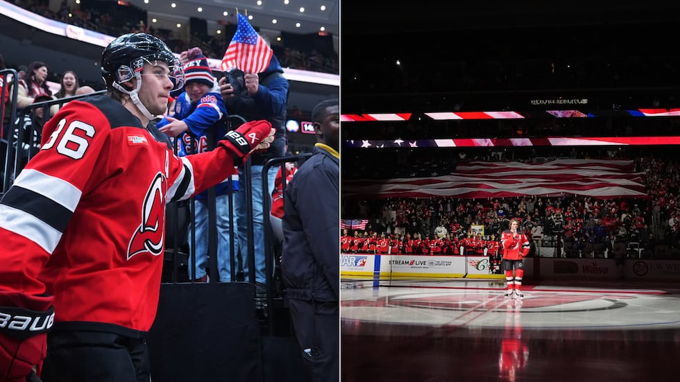 New Jersey Devils' Jack Hughes (86) greets fans as he walks toward the ice before an NHL...