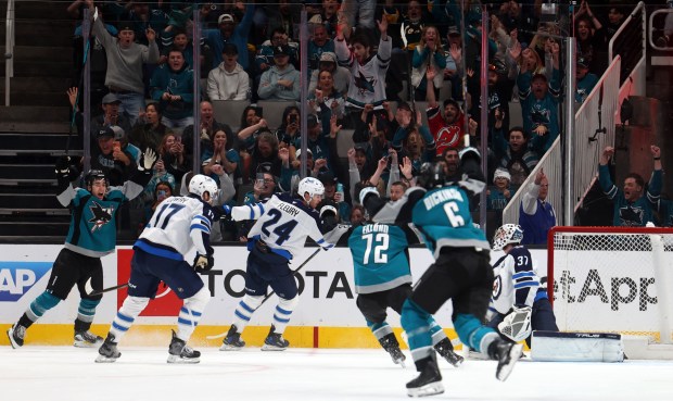 San Jose Sharks forward Michael Misa (77), left, celebrates after scoring the game winning goal in overtime during their game against the Winnipeg Jets on Sunday, March 1, 2026, in San Jose, Calif. (Aric Crabb/Bay Area News Group)