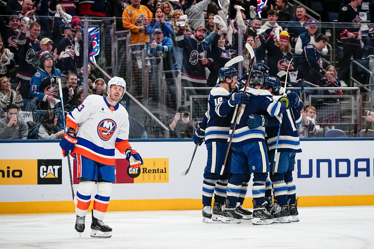 Alex, Knox, Xander and Jaxson Mick of Mt. Vernon, Ohio take photos with Columbus Blue Jackets defenseman Zach Werenski's Team USA Olympic gold medal prior to the NHL hockey game against the New York Islanders at Nationwide Arena in Columbus on Feb. 28, 2026.