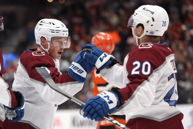 ANAHEIM, CALIFORNIA - MARCH 03: Ross Colton #20 congratulates Cale Makar #8 of the Colorado Avalanche after his goal during the first period of a game against the Anaheim Ducks at Honda Center on March 03, 2026 in Anaheim, California. (Photo by Sean M. Haffey/Getty Images)