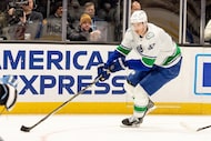 Vancouver Canucks defenseman Tyler Myers looks to move the puck to the goal during the...
